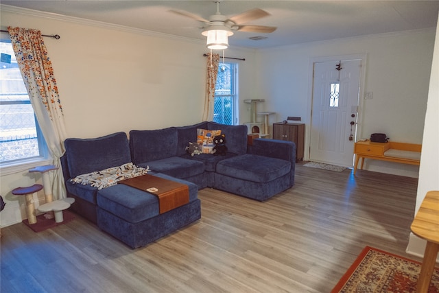 5205 Kashmere St, Houston, TX 77026 - living room with wood finished floors, crown molding, plenty of natural light, and ceiling fan