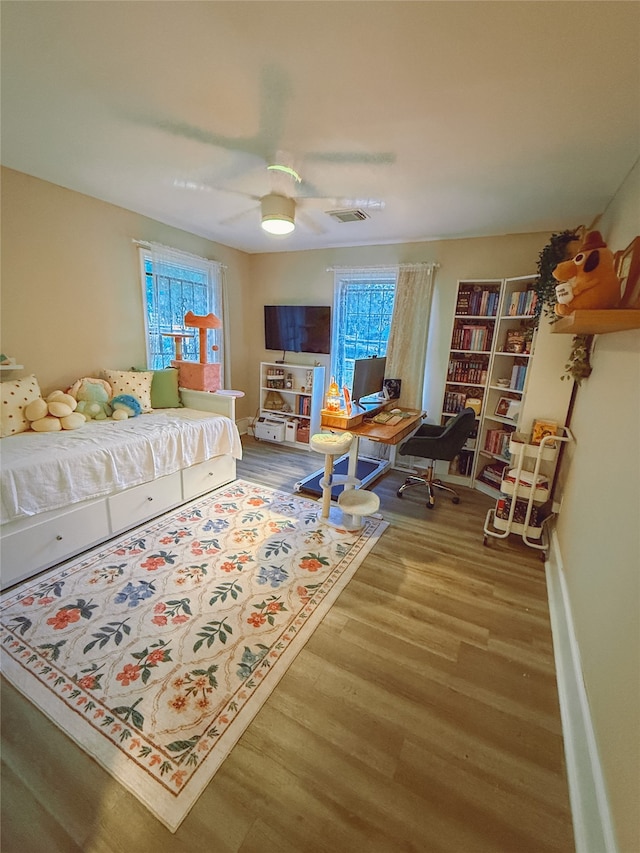 5205 Kashmere St, Houston, TX 77026 - bedroom featuring wood finished floors, multiple windows, and ceiling fan