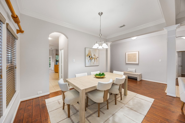 18419 S Raven Shore Dr, Cypress, TX 77433 - dining room featuring arched walkways, wood-type flooring, ornamental molding, and a chandelier