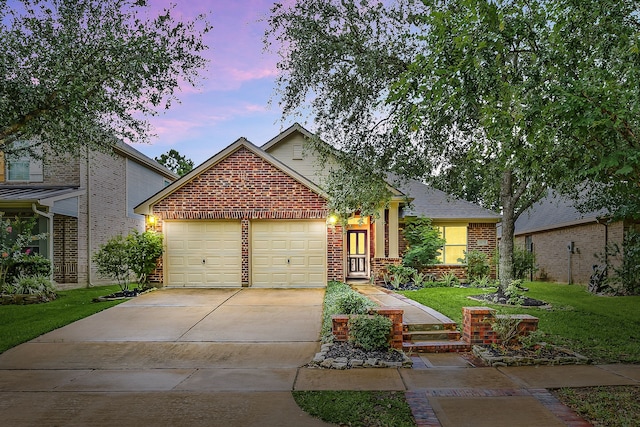 18419 S Raven Shore Dr, Cypress, TX 77433 - view of front of house featuring brick siding, a garage, driveway, and a front lawn