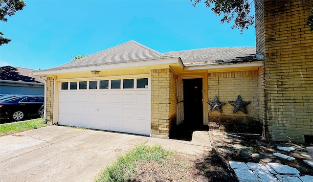 9518 Langdon Ln, Houston, TX 77036 - ranch-style home with brick siding, concrete driveway, a shingled roof, and a garage