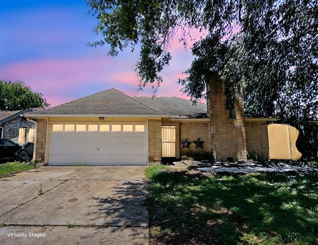 9518 Langdon Ln, Houston, TX 77036 - view of front of house with a garage, driveway, a chimney, and brick siding