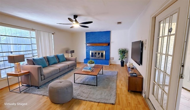 9518 Langdon Ln, Houston, TX 77036 - living area with a ceiling fan, wood finished floors, and a brick fireplace