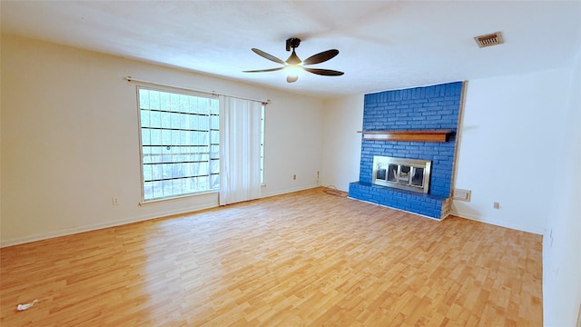 9518 Langdon Ln, Houston, TX 77036 - unfurnished living room with ceiling fan, wood finished floors, and a brick fireplace