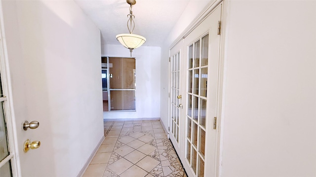 9518 Langdon Ln, Houston, TX 77036 - hallway with french doors and light tile patterned flooring