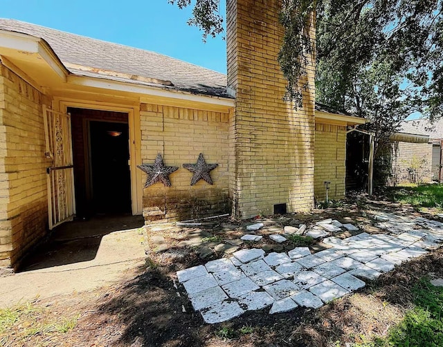 9518 Langdon Ln, Houston, TX 77036 - entrance to property featuring a chimney, brick siding, and a shingled roof