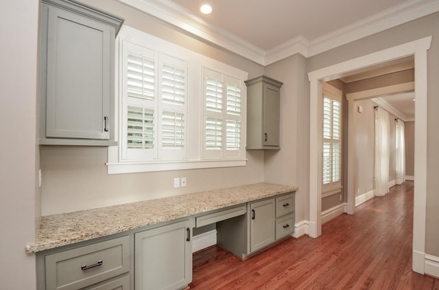 626 E 22nd St, Houston, TX 77008 - unfurnished office featuring built in desk, crown molding, and light wood-type flooring