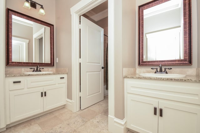 626 E 22nd St, Houston, TX 77008 - bathroom featuring two vanities and baseboards