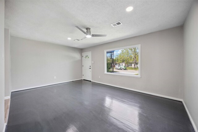 5206 Willow Glen Dr, Houston, TX 77033 - empty room featuring a textured ceiling, ceiling fan, dark wood-style flooring, and recessed lighting