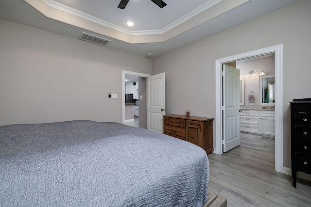 5 Corkwood Rd, Trinity, TX 75862 - bedroom with a tray ceiling, crown molding, light wood-style floors, recessed lighting, and ensuite bath