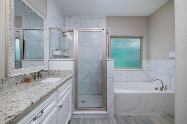 5 Corkwood Rd, Trinity, TX 75862 - full bath with vanity, a bath, a marble finish shower, and wood finished floors