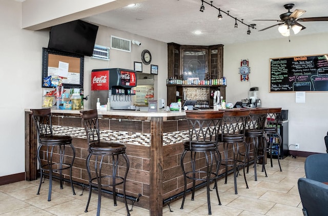 5 Corkwood Rd, Trinity, TX 75862 - indoor dry bar with ceiling fan, tile patterned flooring, and a textured ceiling