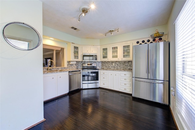 5830 Sampley Way Unit 5830, Houston, TX 77092 - kitchen with appliances with stainless steel finishes, dark wood-style floors, tasteful backsplash, and glass insert cabinets
