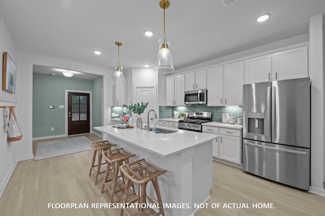 20530 Draper Rd, Tomball, TX 77377 - kitchen featuring stainless steel appliances, light wood-style floors, white cabinetry, backsplash, and recessed lighting