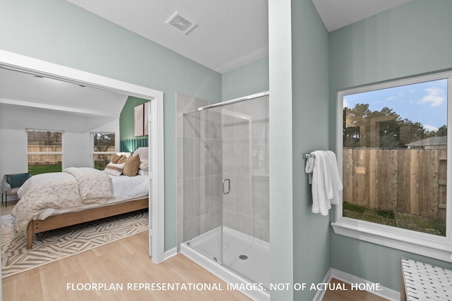 20530 Draper Rd, Tomball, TX 77377 - bathroom featuring connected bathroom, wood finished floors, a stall shower, and healthy amount of natural light