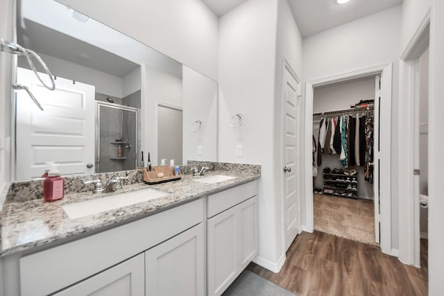 23238 Spring Genesis Ln, Katy, TX 77493 - full bath with a stall shower, a spacious closet, double vanity, and wood finished floors