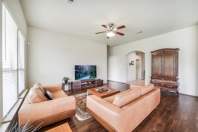 2614 Maverick Park Ln, Katy, TX 77449 - living area with arched walkways, a ceiling fan, dark wood-style flooring, and healthy amount of natural light