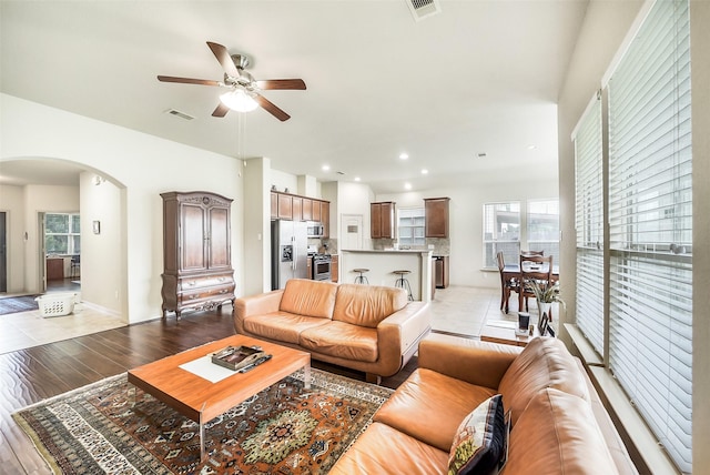 2614 Maverick Park Ln, Katy, TX 77449 - living room with arched walkways, a ceiling fan, light wood-type flooring, and recessed lighting