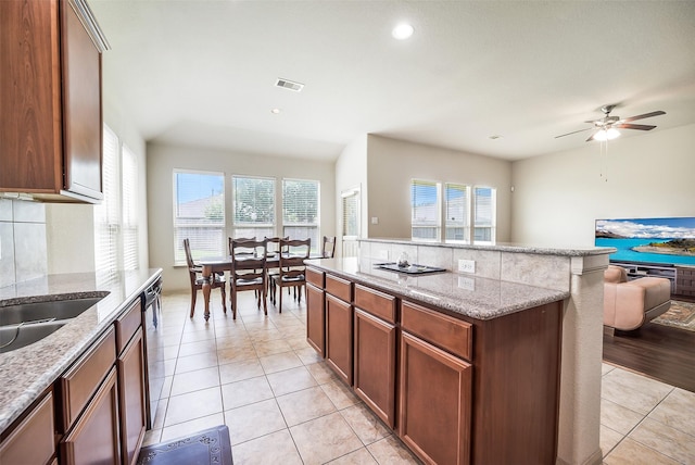 2614 Maverick Park Ln, Katy, TX 77449 - kitchen featuring a kitchen island, healthy amount of natural light, ceiling fan, open floor plan, and recessed lighting