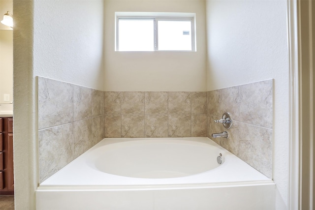 2614 Maverick Park Ln, Katy, TX 77449 - bathroom featuring a garden tub, vanity, and a textured wall