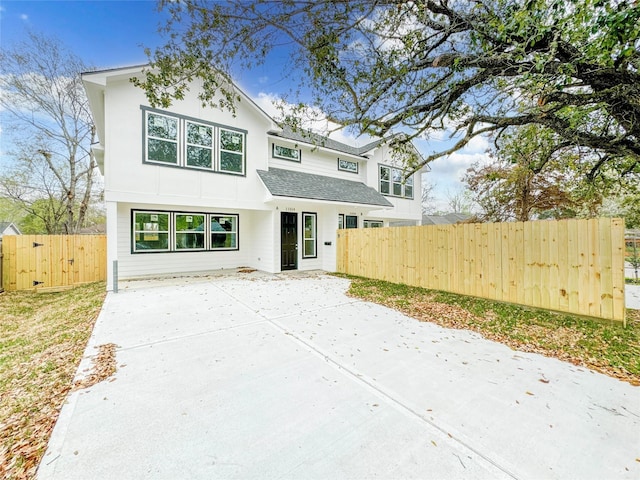 11514 Courtshire Rd, Houston, TX 77076 - view of front of home featuring a gate, concrete driveway, a shingled roof, and a patio