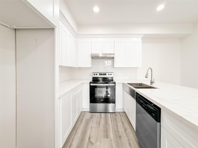 11514 Courtshire Rd, Houston, TX 77076 - kitchen featuring appliances with stainless steel finishes, under cabinet range hood, light wood-type flooring, light stone countertops, and recessed lighting