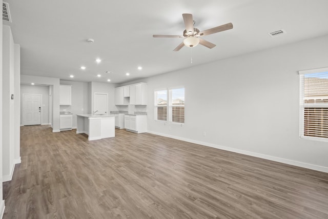 25025 Pomegranate Pl, Montgomery, TX 77316 - unfurnished living room with wood finished floors, recessed lighting, and ceiling fan
