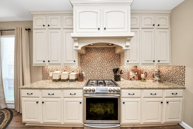 6111 Meadowstream Ct, Katy, TX 77450 - kitchen featuring gas range, backsplash, and light stone counters