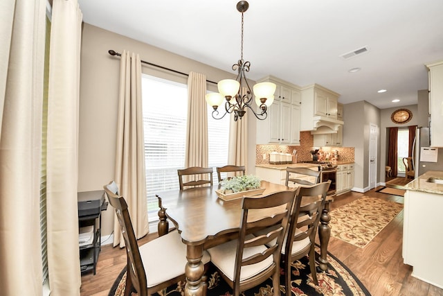 6111 Meadowstream Ct, Katy, TX 77450 - dining room featuring a chandelier, wood finished floors, and recessed lighting