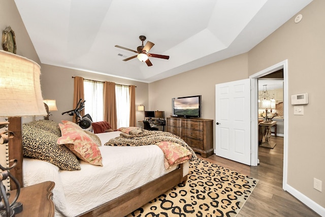 6111 Meadowstream Ct, Katy, TX 77450 - bedroom featuring wood finished floors, a ceiling fan, and a tray ceiling