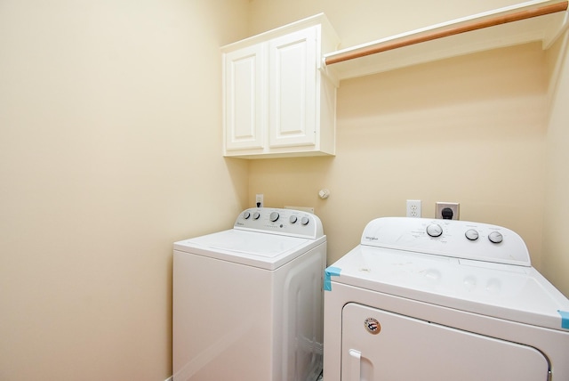 14431 Basalt Ln, Houston, TX 77077 - laundry room with washer and clothes dryer and cabinet space