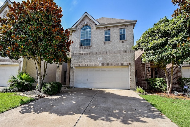 14431 Basalt Ln, Houston, TX 77077 - view of front of house with brick siding, driveway, and a garage