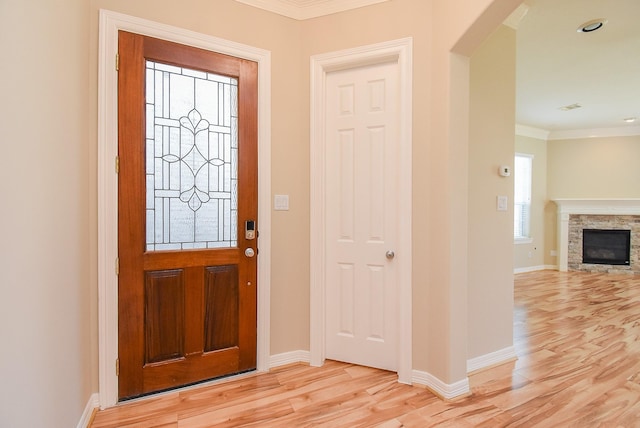 14431 Basalt Ln, Houston, TX 77077 - foyer entrance featuring crown molding, light wood-style flooring, and a stone fireplace