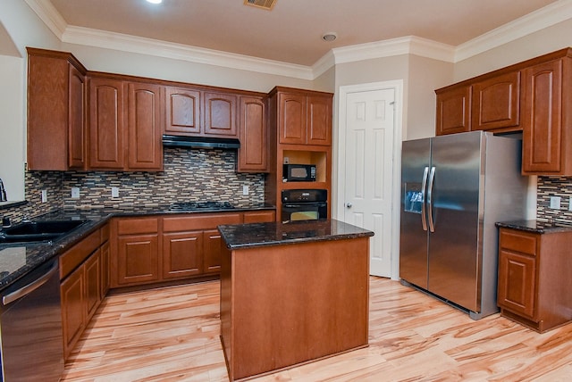 14431 Basalt Ln, Houston, TX 77077 - kitchen featuring black appliances, a kitchen island, light wood-style flooring, dark stone counters, and ornamental molding
