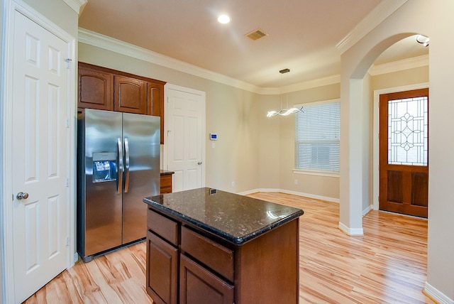 14431 Basalt Ln, Houston, TX 77077 - kitchen with stainless steel refrigerator with ice dispenser, light wood-type flooring, a kitchen island, crown molding, and dark stone countertops