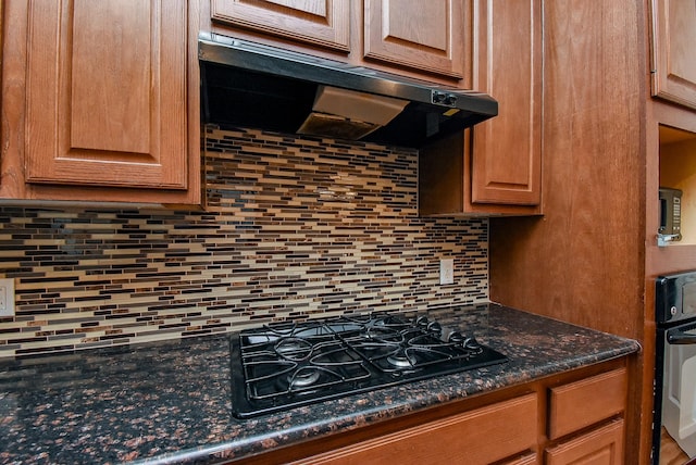 14431 Basalt Ln, Houston, TX 77077 - kitchen featuring black appliances, tasteful backsplash, and range hood
