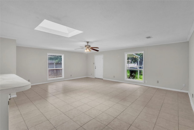 11515 Duane St, Houston, TX 77047 - spare room with a skylight, crown molding, ceiling fan, and light tile patterned floors