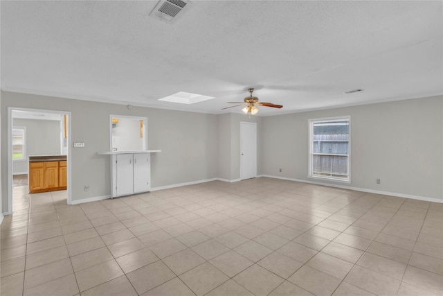 11515 Duane St, Houston, TX 77047 - unfurnished room featuring ceiling fan, a skylight, light tile patterned floors, and crown molding