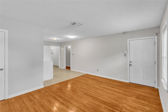 11515 Duane St, Houston, TX 77047 - empty room with light wood-style floors and a textured ceiling