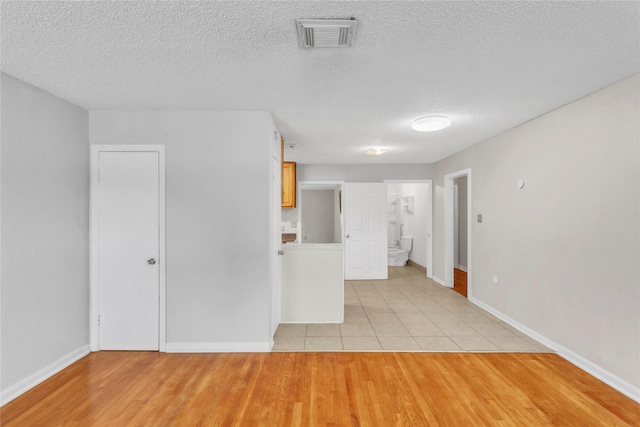 11515 Duane St, Houston, TX 77047 - spare room with light wood finished floors and a textured ceiling