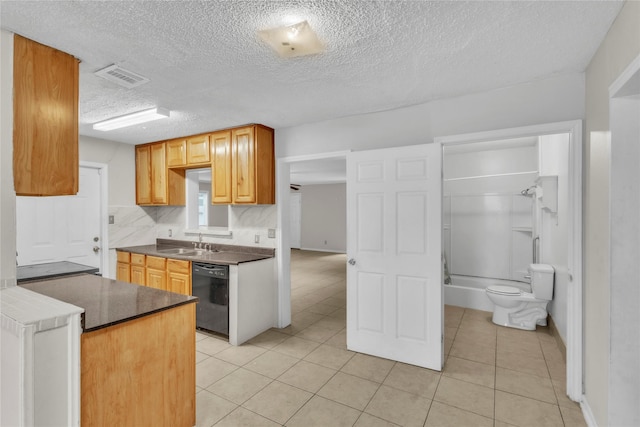 11515 Duane St, Houston, TX 77047 - kitchen with dishwasher, light tile patterned floors, a textured ceiling, dark countertops, and decorative backsplash