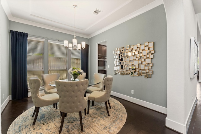 22 Mayapple Blossom Pl, Tomball, TX 77375 - dining space with a chandelier, a raised ceiling, dark wood finished floors, and crown molding