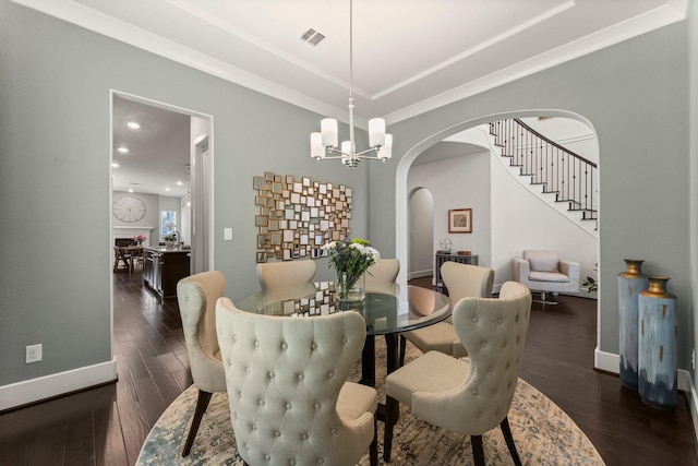 22 Mayapple Blossom Pl, Tomball, TX 77375 - dining room featuring arched walkways, wood finished floors, a chandelier, stairs, and a tray ceiling