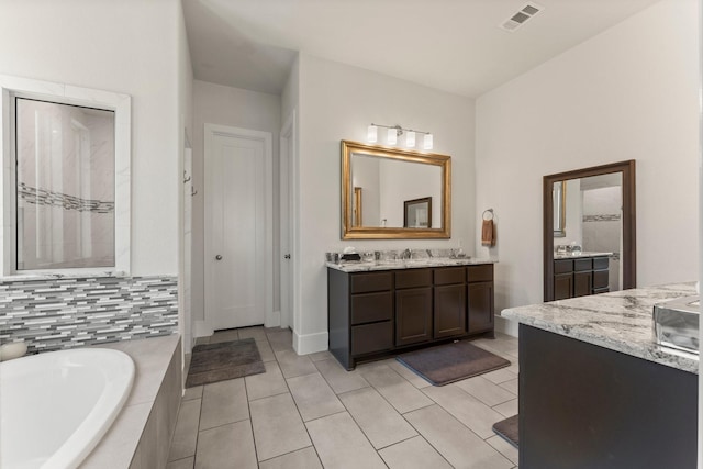 22 Mayapple Blossom Pl, Tomball, TX 77375 - bathroom with two vanities, a garden tub, and tile patterned flooring