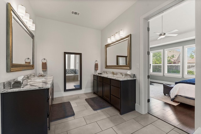 22 Mayapple Blossom Pl, Tomball, TX 77375 - ensuite bathroom featuring two vanities, ceiling fan, and tile patterned floors