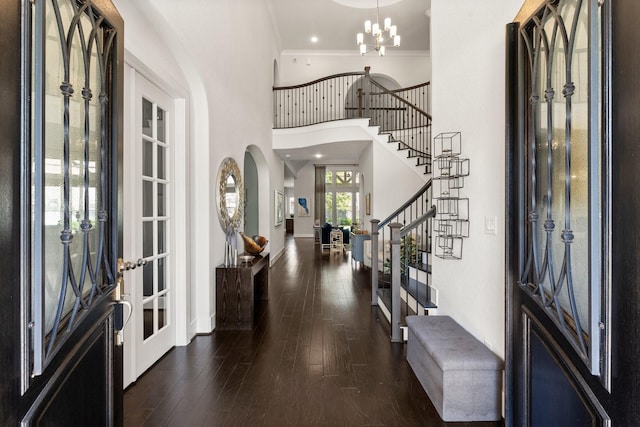 22 Mayapple Blossom Pl, Tomball, TX 77375 - foyer entrance with stairway, a high ceiling, hardwood / wood-style floors, arched walkways, and crown molding