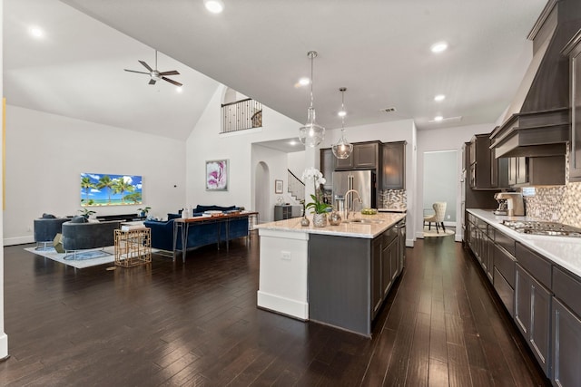 22 Mayapple Blossom Pl, Tomball, TX 77375 - kitchen featuring open floor plan, appliances with stainless steel finishes, a ceiling fan, wall chimney range hood, and arched walkways