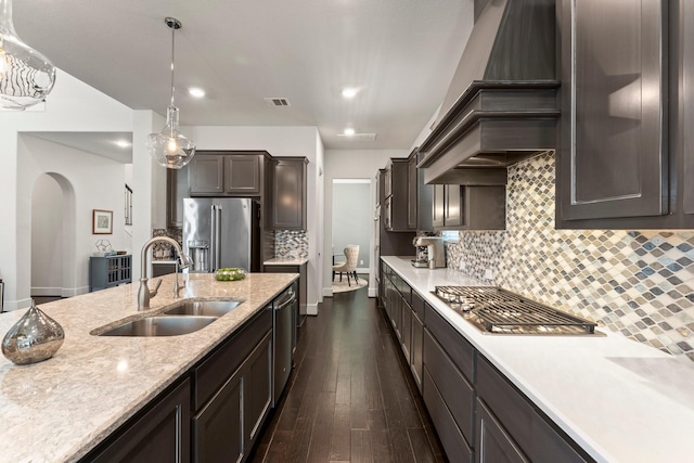 22 Mayapple Blossom Pl, Tomball, TX 77375 - kitchen with stainless steel appliances, custom range hood, arched walkways, dark wood-type flooring, and decorative light fixtures