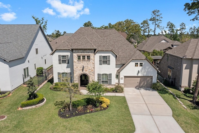 22 Mayapple Blossom Pl, Tomball, TX 77375 - french country inspired facade featuring stone siding, stucco siding, driveway, and a shingled roof