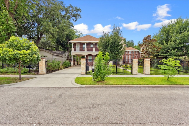 4511 Palo Pinto Dr, Houston, TX 77041 - mediterranean / spanish house featuring a carport, driveway, a fenced front yard, and a gate